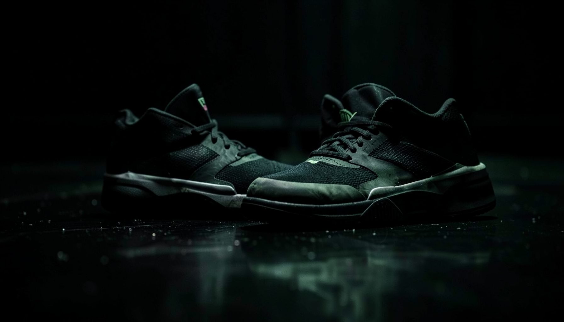Dark atmospheric display of basketball sneakers on a glossy floor, deep blacks and muted greens with subtle reflections