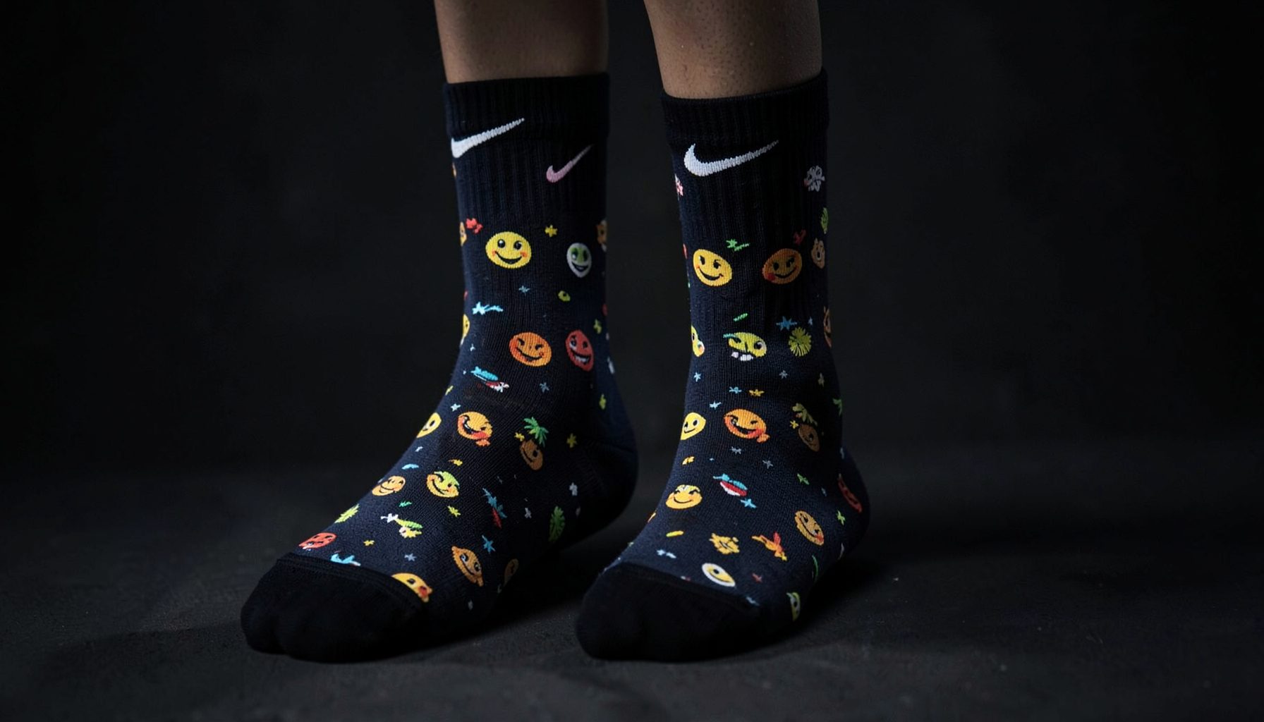 Custom-designed Nike Elite socks with emoji pattern, dark moody presentation
